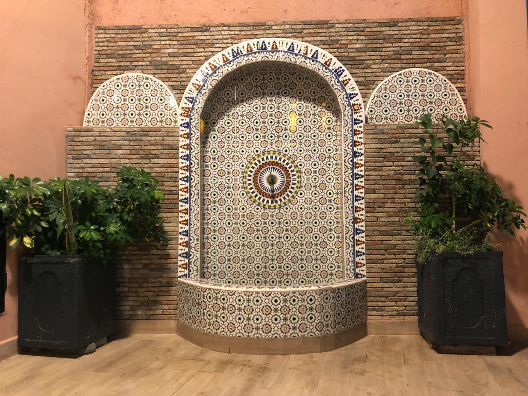 Ornate fountain design in traditional Moroccan courtyard setting